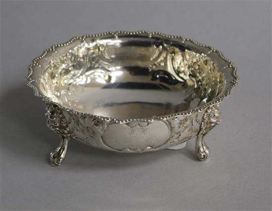 A Victorian embossed silver sugar bowl, on claw and ball feet, Robert Harper, London, 1874, 12.1cm.